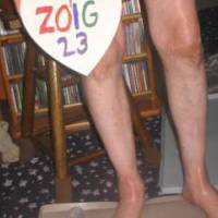 A lower body & dick frontal scene as I stand in front of my CD rack  & bar stool, plus  a splat mat on the floor. Camera used, Canon G6.