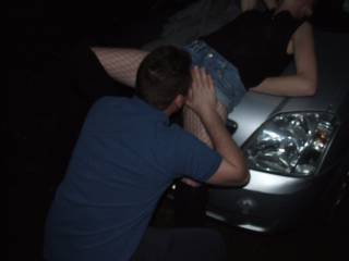 Joanne lay on the bonnet while this young man licked her pussy