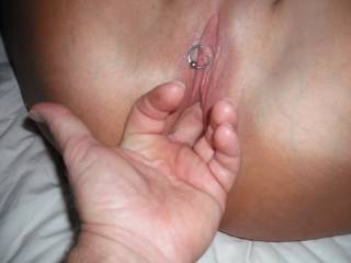 Fingering her lovely, neat, smooth, pierced, pussy.