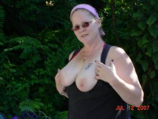 My wife flashing her tits in the backyard.