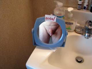 Shaving mirror reflecting a clean shaved cock and balls.