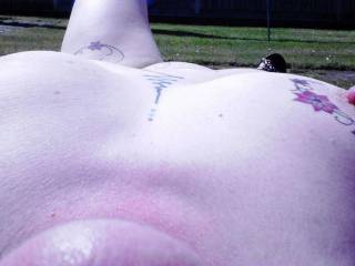 Totally naked in a park! Sally relaxing.