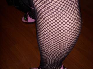 A shot of Jen's sexy legs in fishnets and stripper heels.
