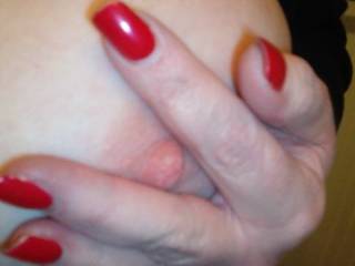 Cindy shows us some of her sweet, pink nipple! Don't you love that red fingernail polish?