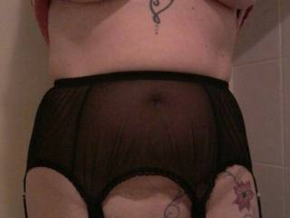 A proper 6 strap suspender belt being worn by Sally. Just a skirt will complete her daily outfit.