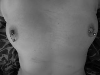Our sub girlfriend enjoying her punishment for making us wait too long to play with her. She is tied down and nipples ringed. This is how Mr. Likes makes you ours. Notice the whip marks across lovely chest.