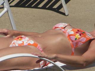 my girlfriend sunning herself at the hotel pool
