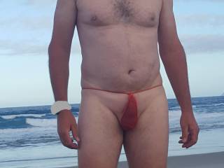 Showing off my smooth cock in a red G-string at the beach. Got a few looks. Would you look?