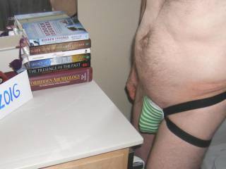 Standing near the bathroom counter & books, wearing my lingerie.