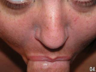 So hot seeing her hot lips wrapped around that nice, thick, hard cock while her sexy eyes are focused on the camera.  Great pic.