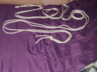 My girlfriend laying on the bed before session. Thought would try to spell zig with one of the ropes before the bondage began.