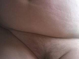Wife laying on her side big wobbly belly flopped over and hairy pussy. Needs cum don't you think?