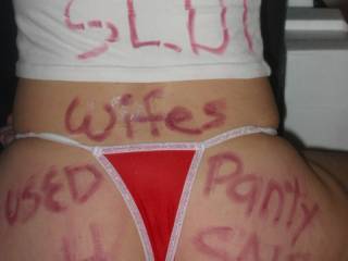 angel written on with red lipstick , she has wet cum soaked panties on