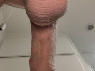 View from below of my freshly shaved uncut cock and pert cum laden balls bursting with spunk
