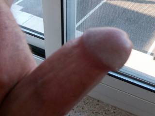 Jacking off in hotel room window.  Wish she would look up and watch me jack my dick off on the window!