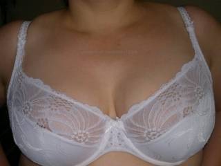 A simple white bra holding my wifes gorgeous tits. I love the way you can just see her nipples through the lace.