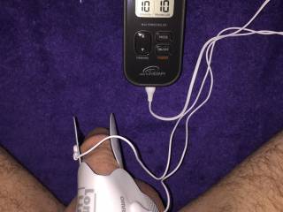 Still shot of my first electrosex setup showing my Omron stimulator and the large sticky pads on my cock.  I've come such a long way since this day!