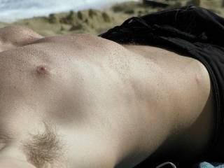 on beach , him looking fine, see the trickle of pube hair