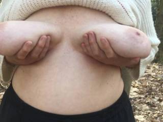 1 of 2 - made last weekend. We are on top of a small hill in woodland, with a road the other side of the hedgerow behind my friend. She lifts her big tits up and gently squeezes them.