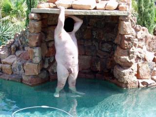 My hubby is nervously posing nude for me in our pool!  The neighbor lady and her female friends were in her backyard and had a perfect view of him had they paid attention!