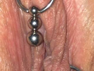 I've never had the opportunity to try this, but I'd like to see a thread or elastic tied around the top of each thigh, threaded through her lip rings; as she opens her legs it should part her lips, presenting open pussy, mmmm!
