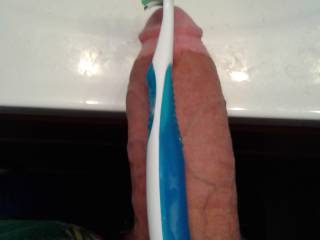 Balencing my toothbrush with my thick cock