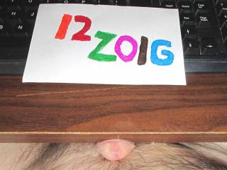A view of my dick head and the pool of cum on the desk.