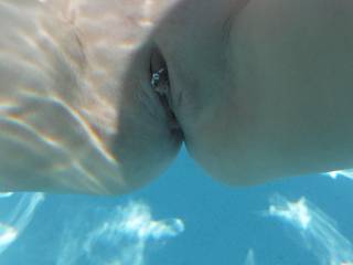 Underwater close-up of my shaven and pierced pussy, in the swimming pool at home, earlier this year