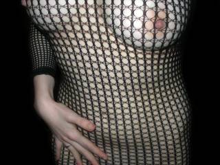 Amazing body and we love her beautiful tits and sexy nipples poking through the fishnet.  Awesome pic of this hottie.