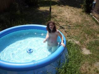 my wife still looks good at 5 months pregnant as she relaxes in pool