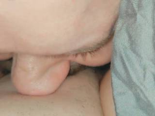 My friend handed me his phone as he spread my legs and slid his tongue between my wet pussy lips and started licking and sucking my clit! I loved it when he pushed his tongue in my pussy too! I came right on his mouth a few times!!